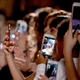 Everyone holds up their phones to take photos at London Fashion Week February 2017 (Photo by Jeff Spicer/Getty Images)